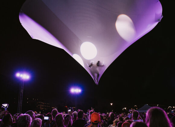 Muaré Experience - artysta unoszący się nad publiczością w balonie